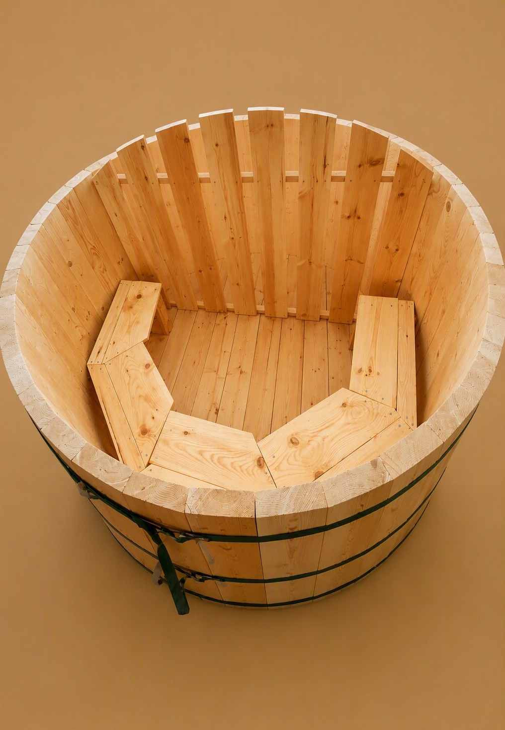 Wood-fired soaking tub in a backyard setting with trees, deck, and stainless steel chimney